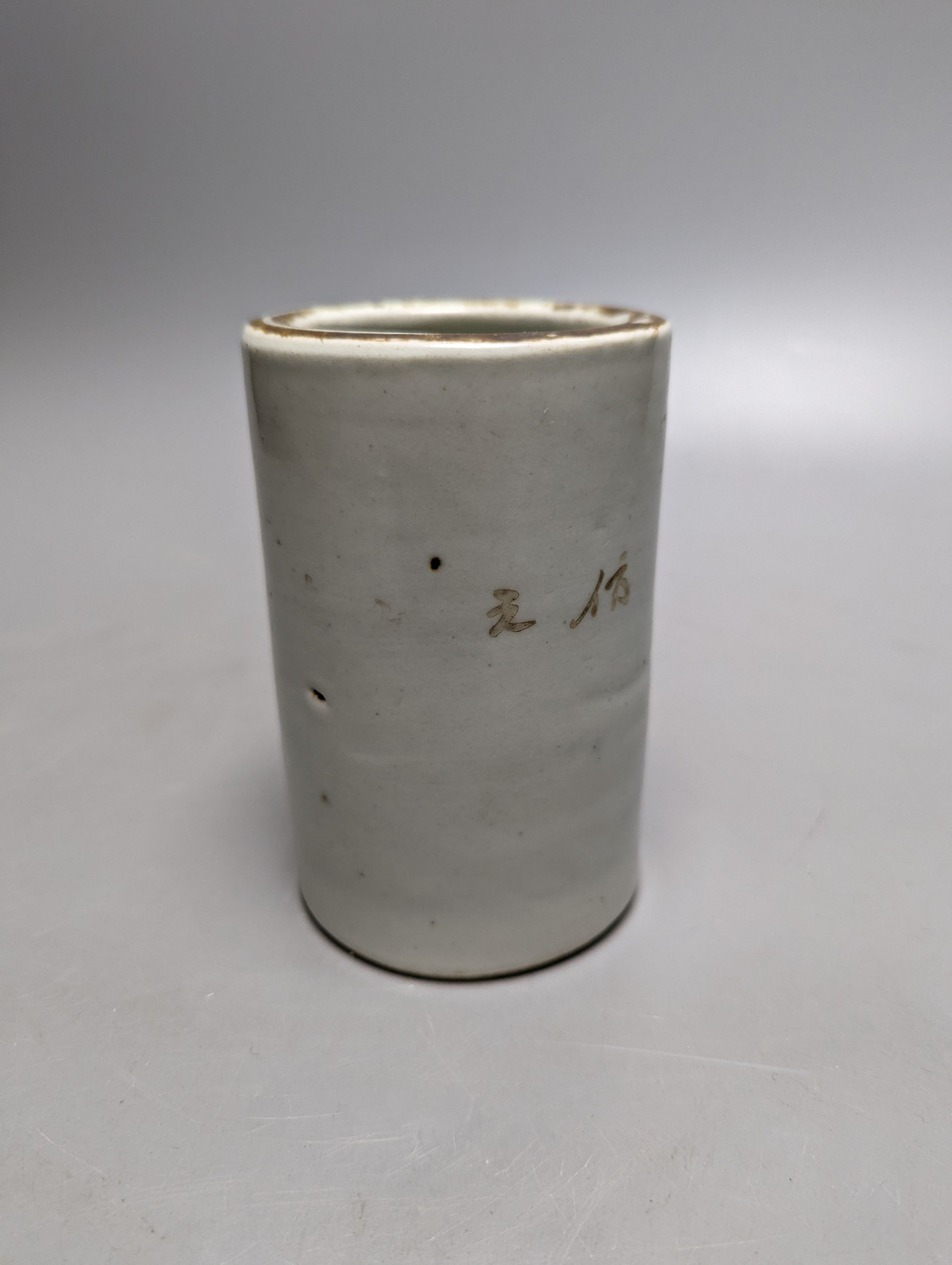 An early 20th century iron red enamelled 'lion' brush pot 12cm